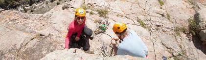 Two students rock climb in sinks canyon state park